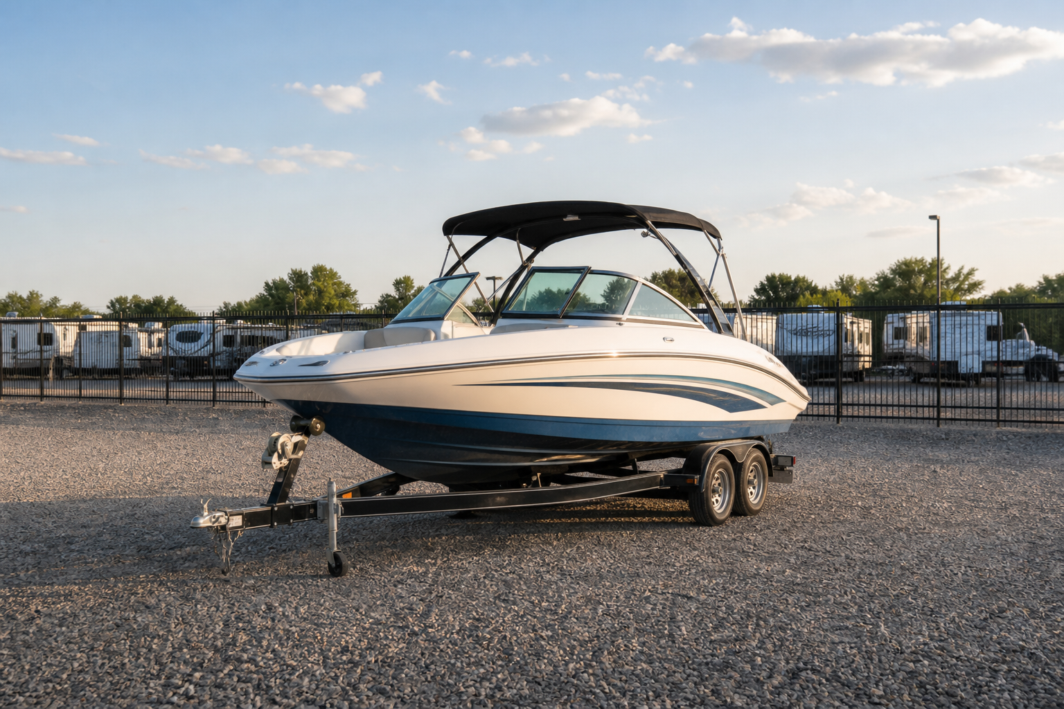 Boat on a trailer parked in an outdoor storage lot